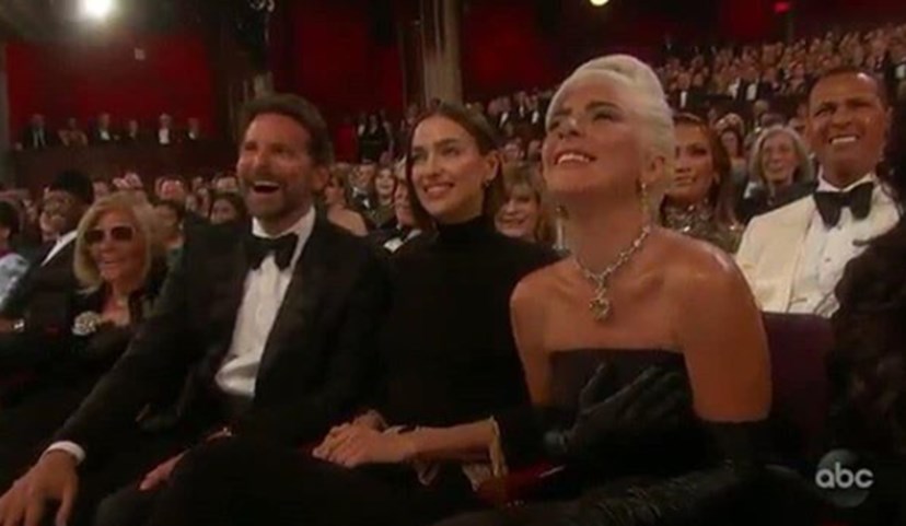 Irina sentada entre Bradley e Lady Gaga