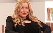 Apresentadora de televisão surge em cenário de estúdio